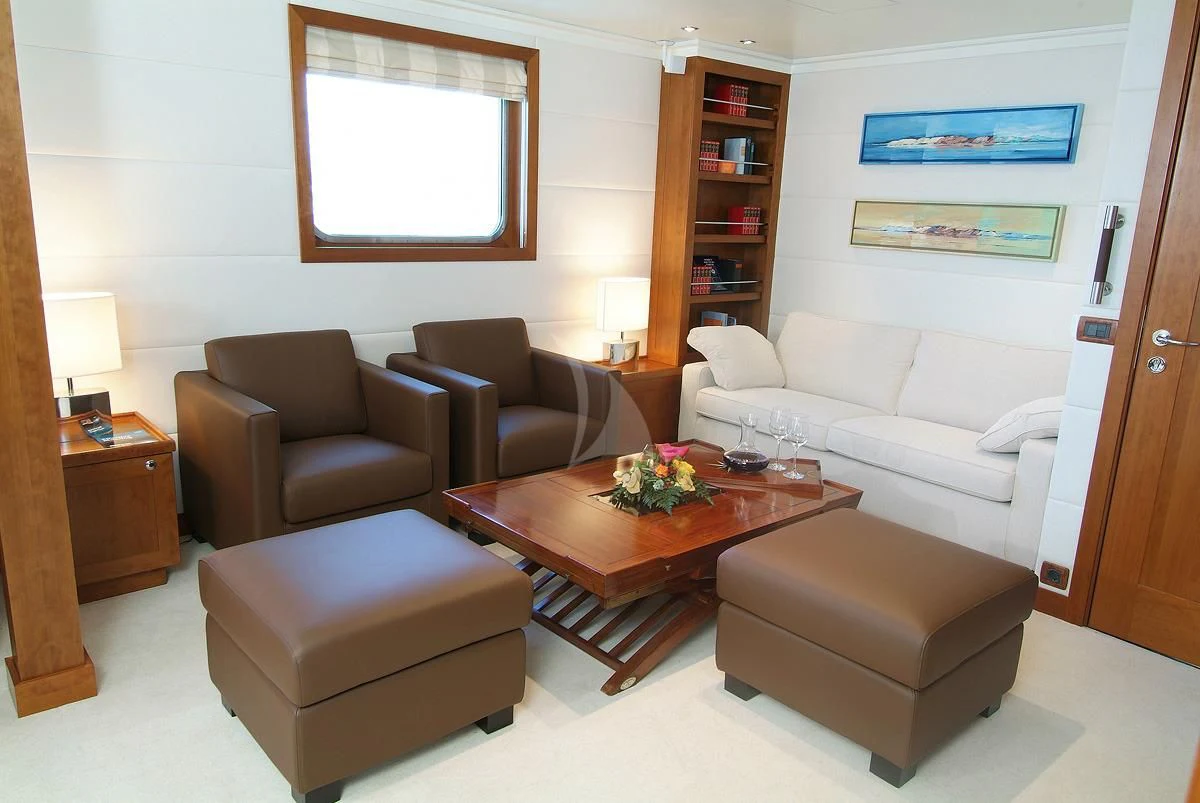 a living room with a couch and a coffee table aboard HANSE EXPLORER Yacht for Sale