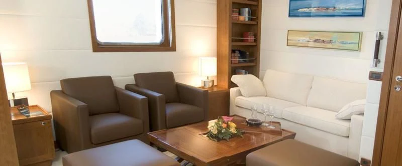 a living room with a couch and a table aboard HANSE EXPLORER Yacht for Sale