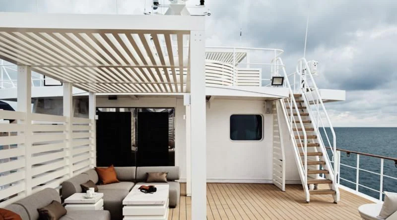 a white house with a large deck overlooking the ocean aboard HANSE EXPLORER Yacht for Sale