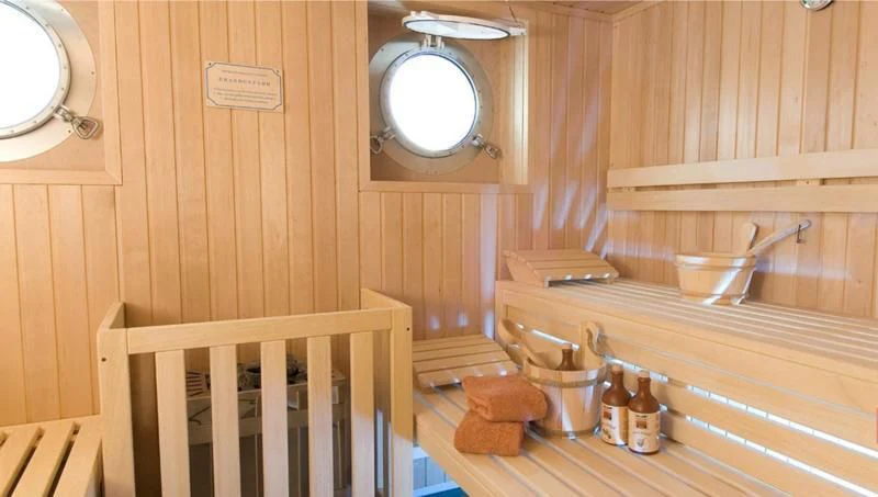 a wooden bathroom with a sink and a mirror aboard HANSE EXPLORER Yacht for Sale