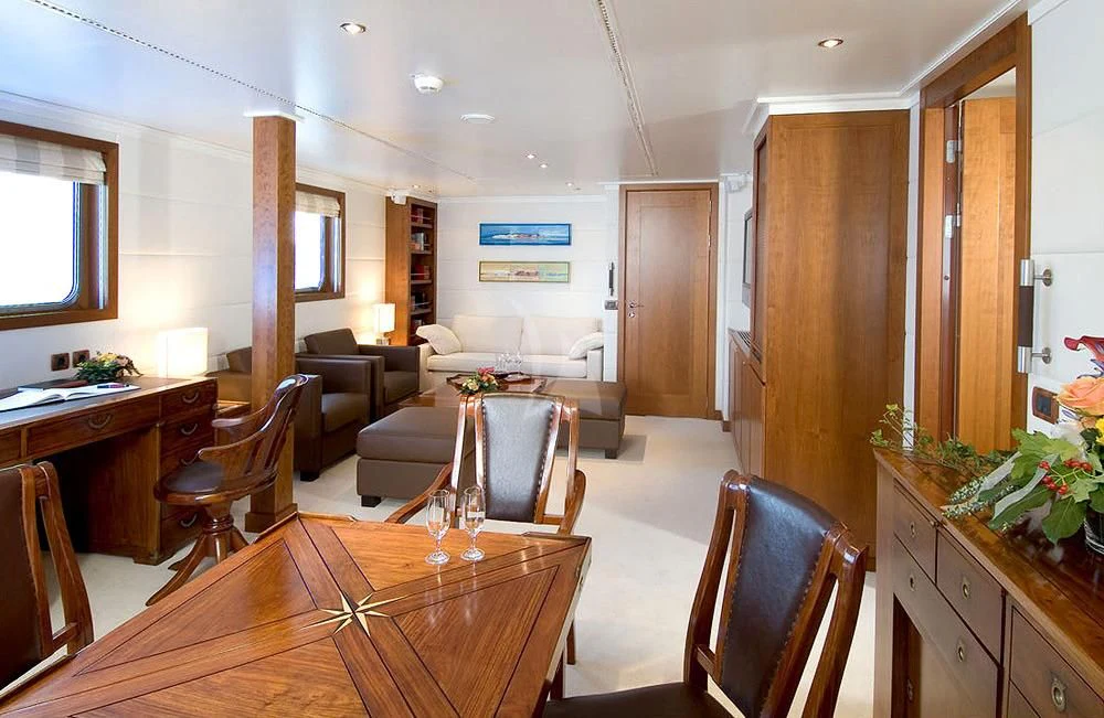 a living room with a table and chairs aboard HANSE EXPLORER Yacht for Sale
