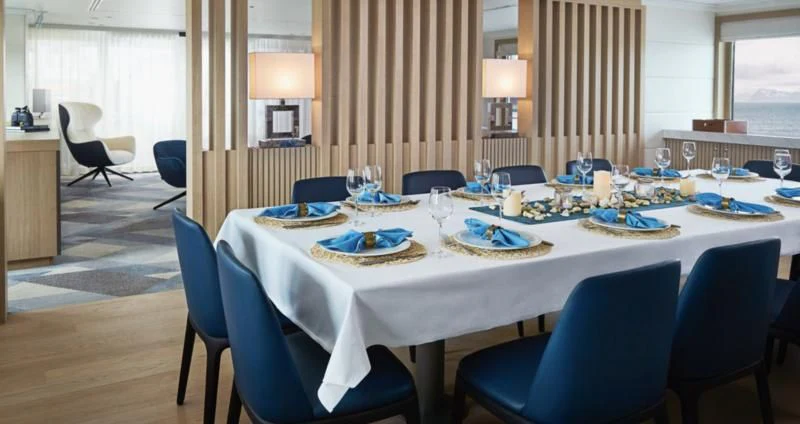 a large dining room with a table set for dinner aboard HANSE EXPLORER Yacht for Sale