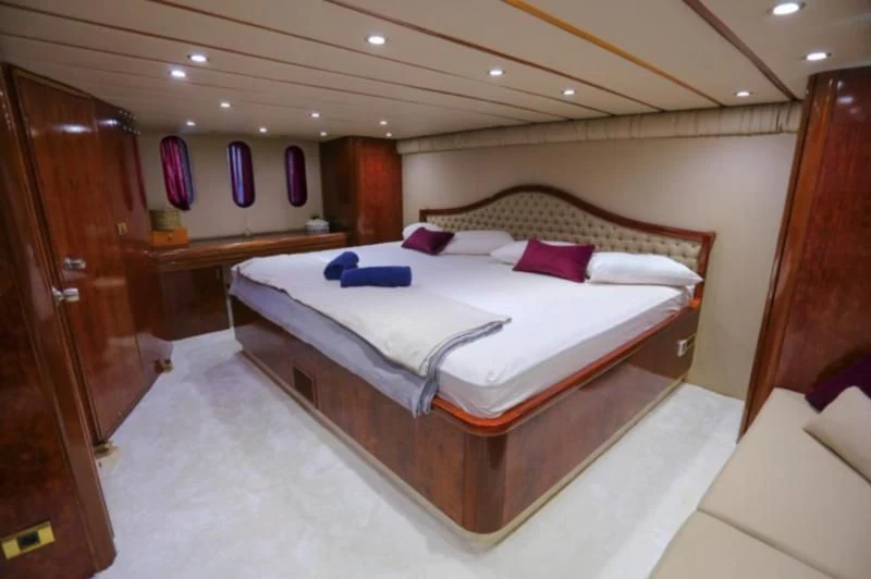 a room with a bed and a wood door aboard ERDOGAN Yacht for Sale
