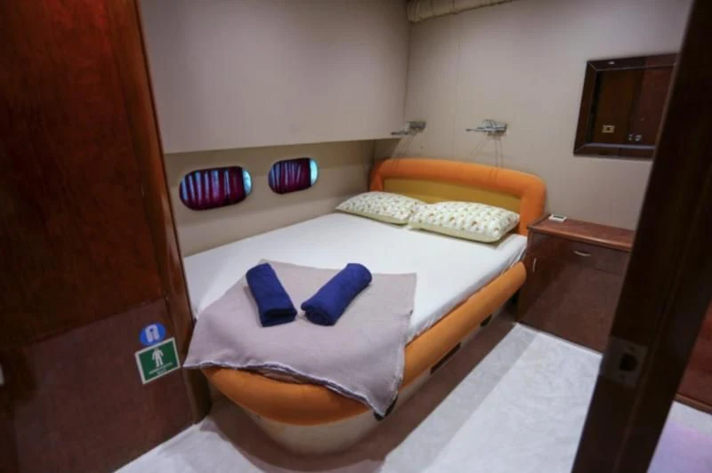 a room with a bed and a television aboard ERDOGAN Yacht for Sale