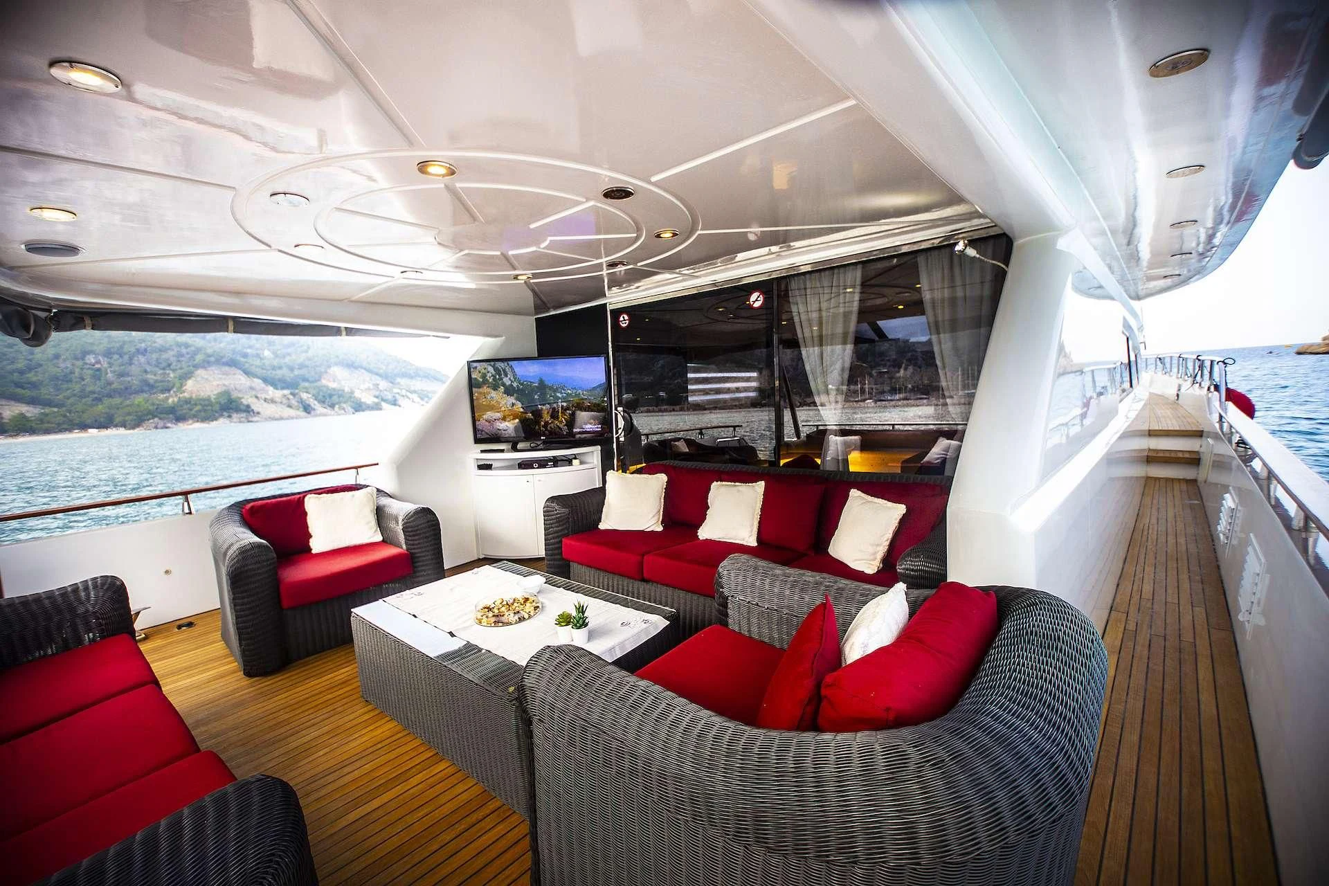 a large living room with a view of the ocean aboard ERDOGAN Yacht for Sale
