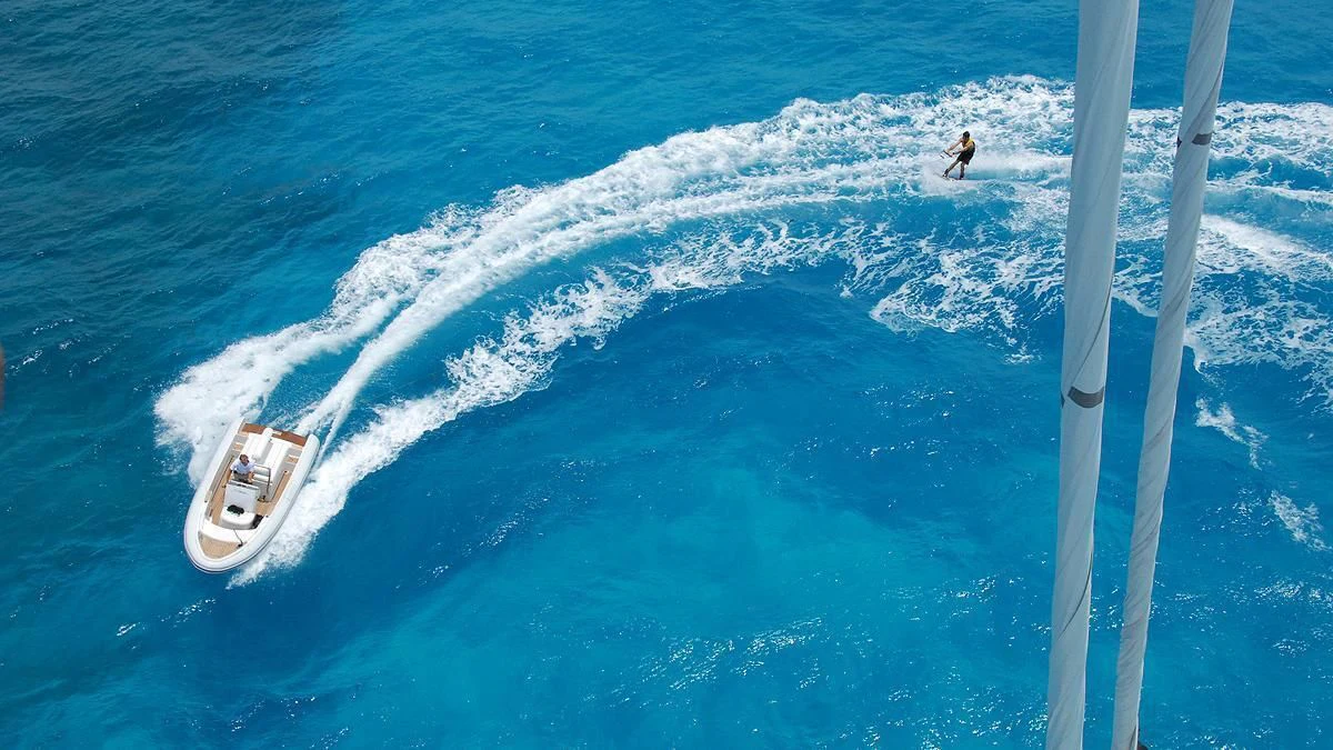 a person surfing on the sea aboard HYPERION Yacht for Charter