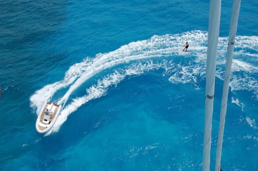 a person surfing on the sea aboard HYPERION Yacht for Charter