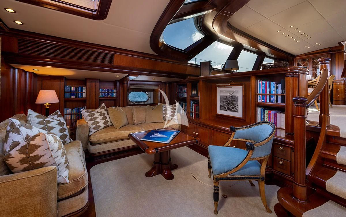 a living room with a bookcase and a couch aboard HYPERION Yacht for Charter