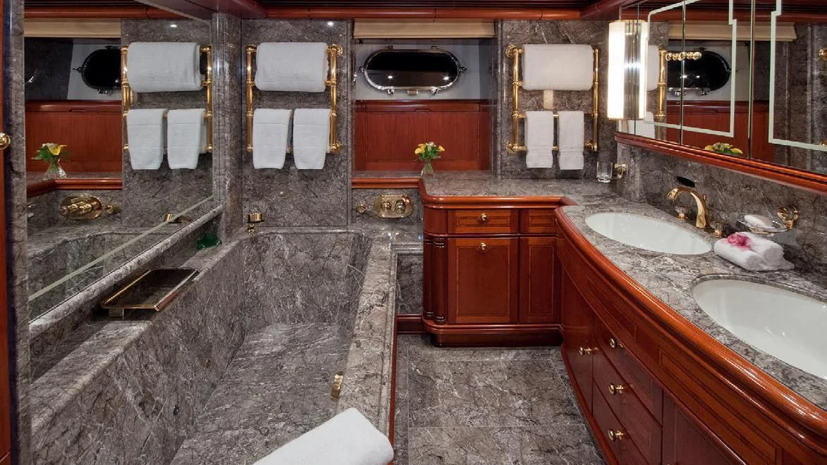 a bathroom with a bathtub sink and a sink aboard HYPERION Yacht for Charter