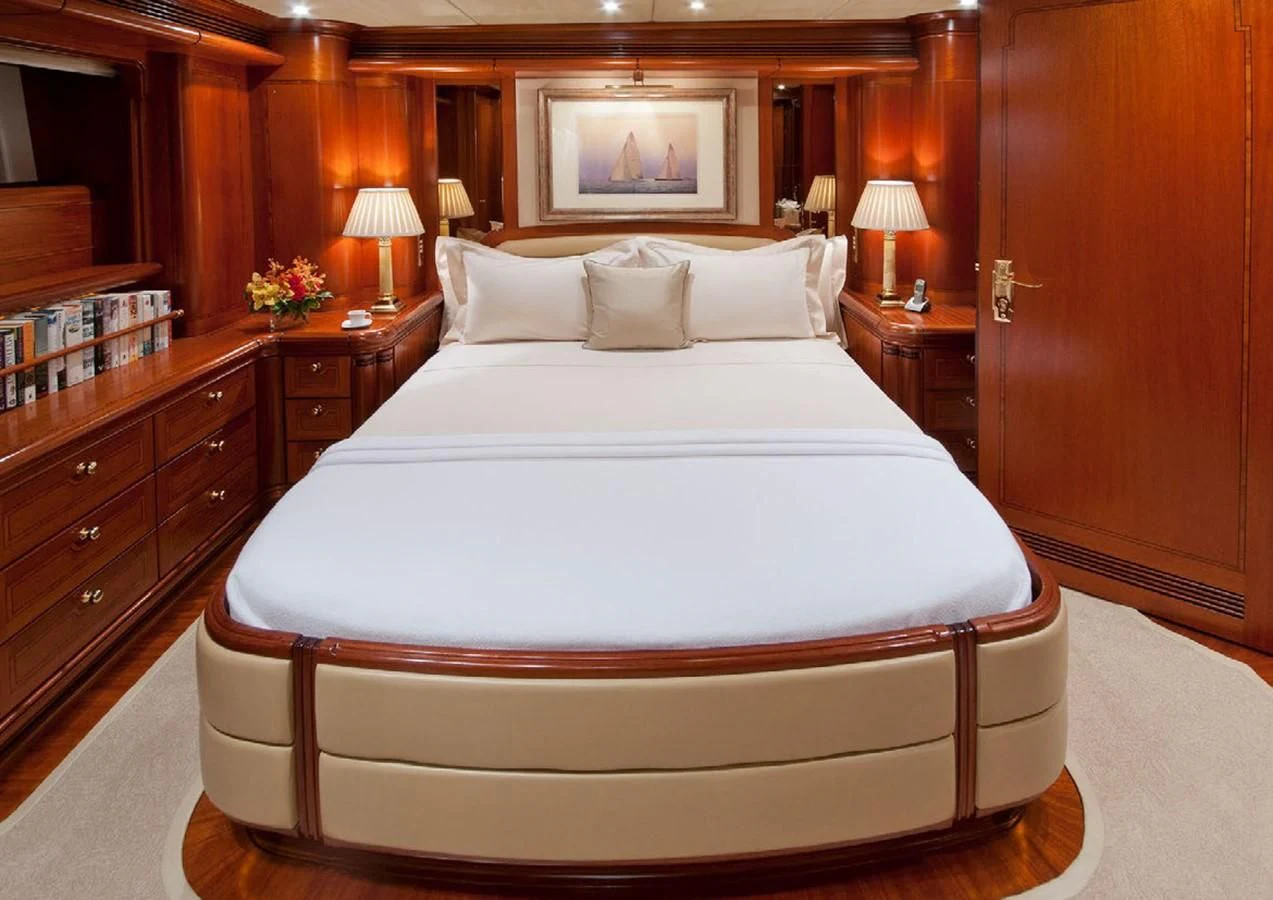 a bed with white sheets and pillows aboard HYPERION Yacht for Charter