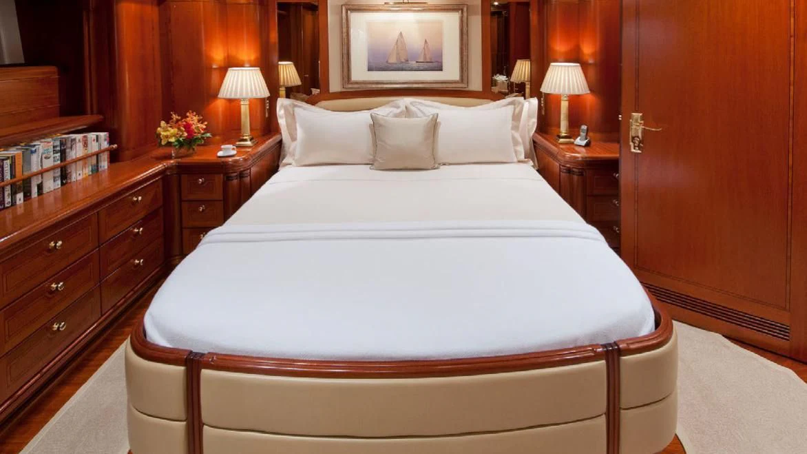 a bed with white sheets and pillows aboard HYPERION Yacht for Charter