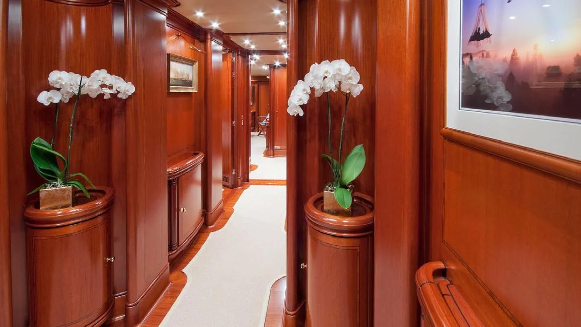 a hallway with a plant and flowers aboard HYPERION Yacht for Charter