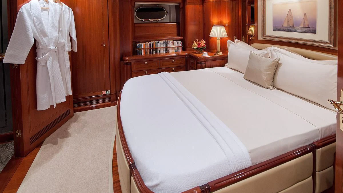 a bed with white sheets aboard HYPERION Yacht for Charter