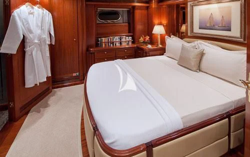 a bed with a white sheet aboard HYPERION Yacht for Charter