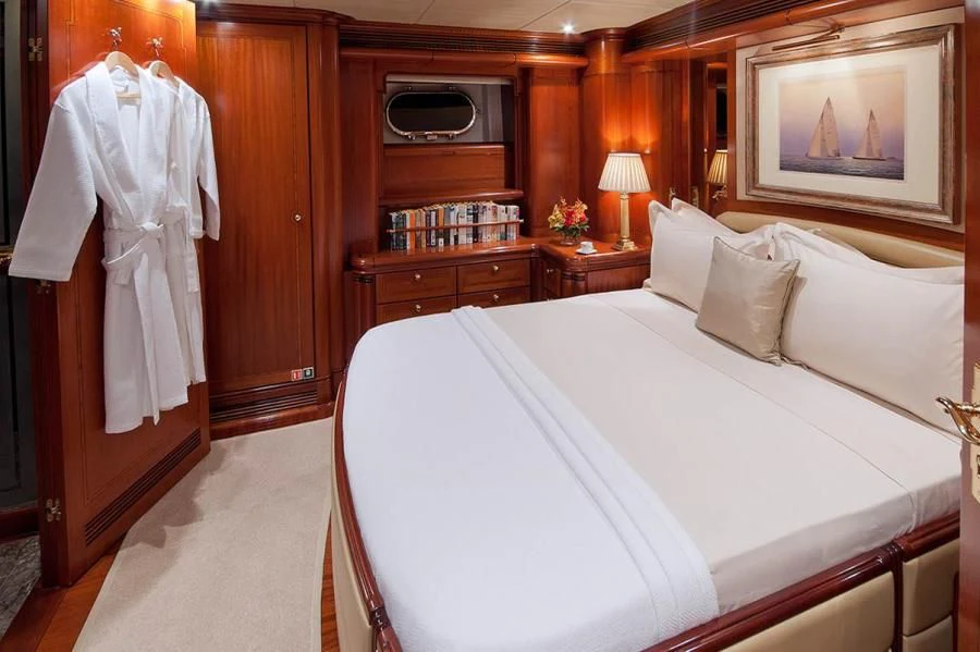 a bed with white sheets and pillows aboard HYPERION Yacht for Charter