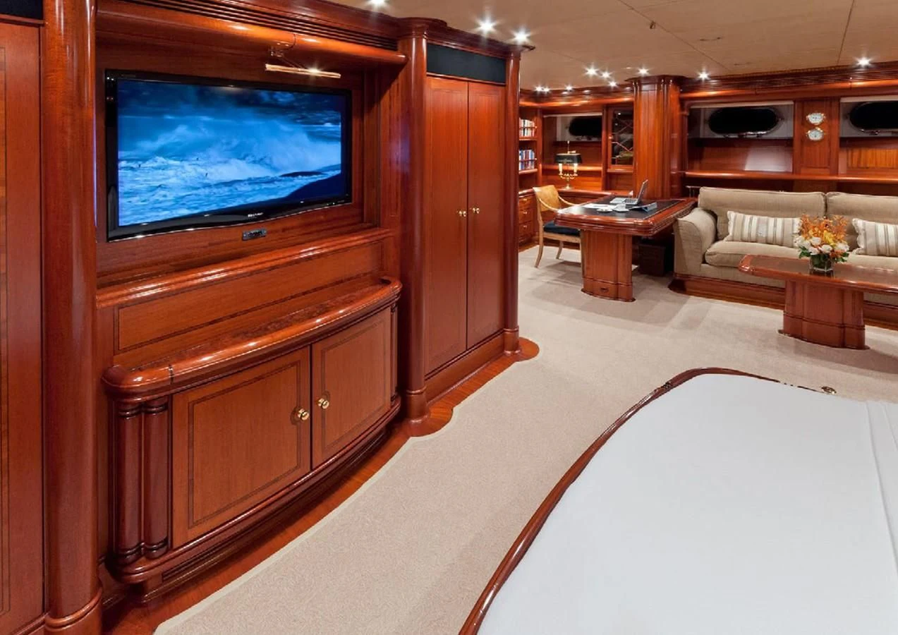 a room with a tv and a couch aboard HYPERION Yacht for Charter