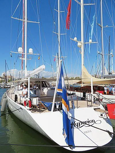 a boat with a blue and white sail aboard HYPERION Yacht for Charter
