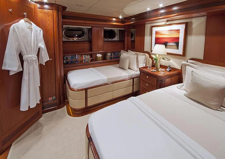 a room with a bed and a desk aboard HYPERION Yacht for Charter