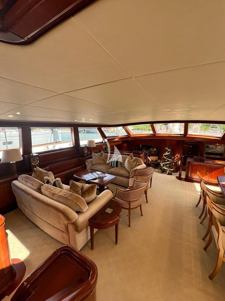 a living room with a couch and a table aboard HYPERION Yacht for Charter