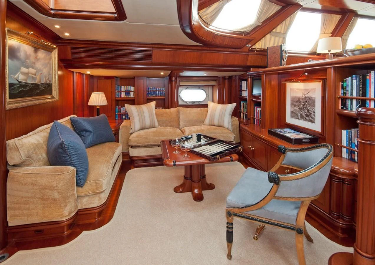 a living room with a couch and a table aboard HYPERION Yacht for Charter