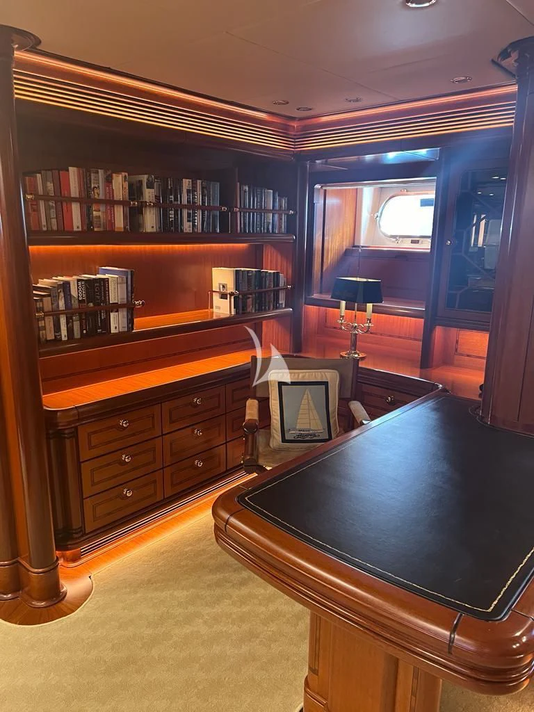a room with a tv and a book shelf aboard HYPERION Yacht for Charter