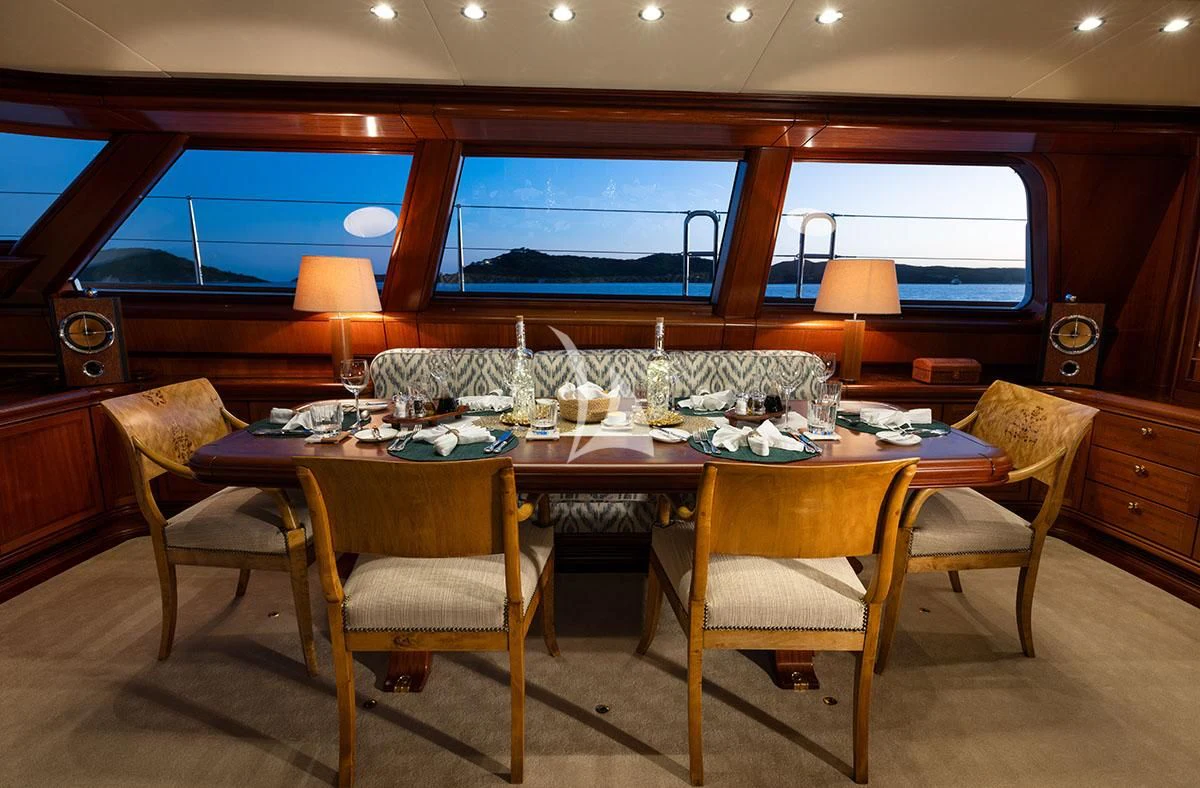 a table with chairs around it aboard HYPERION Yacht for Charter