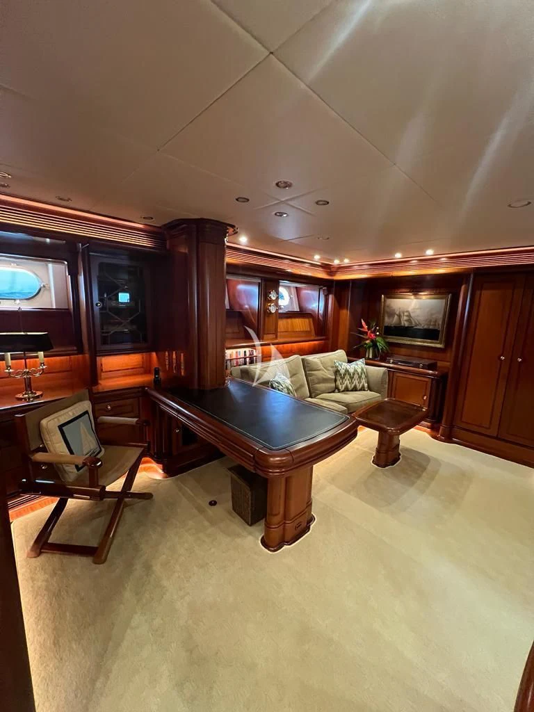 a living room with a table and couches aboard HYPERION Yacht for Charter