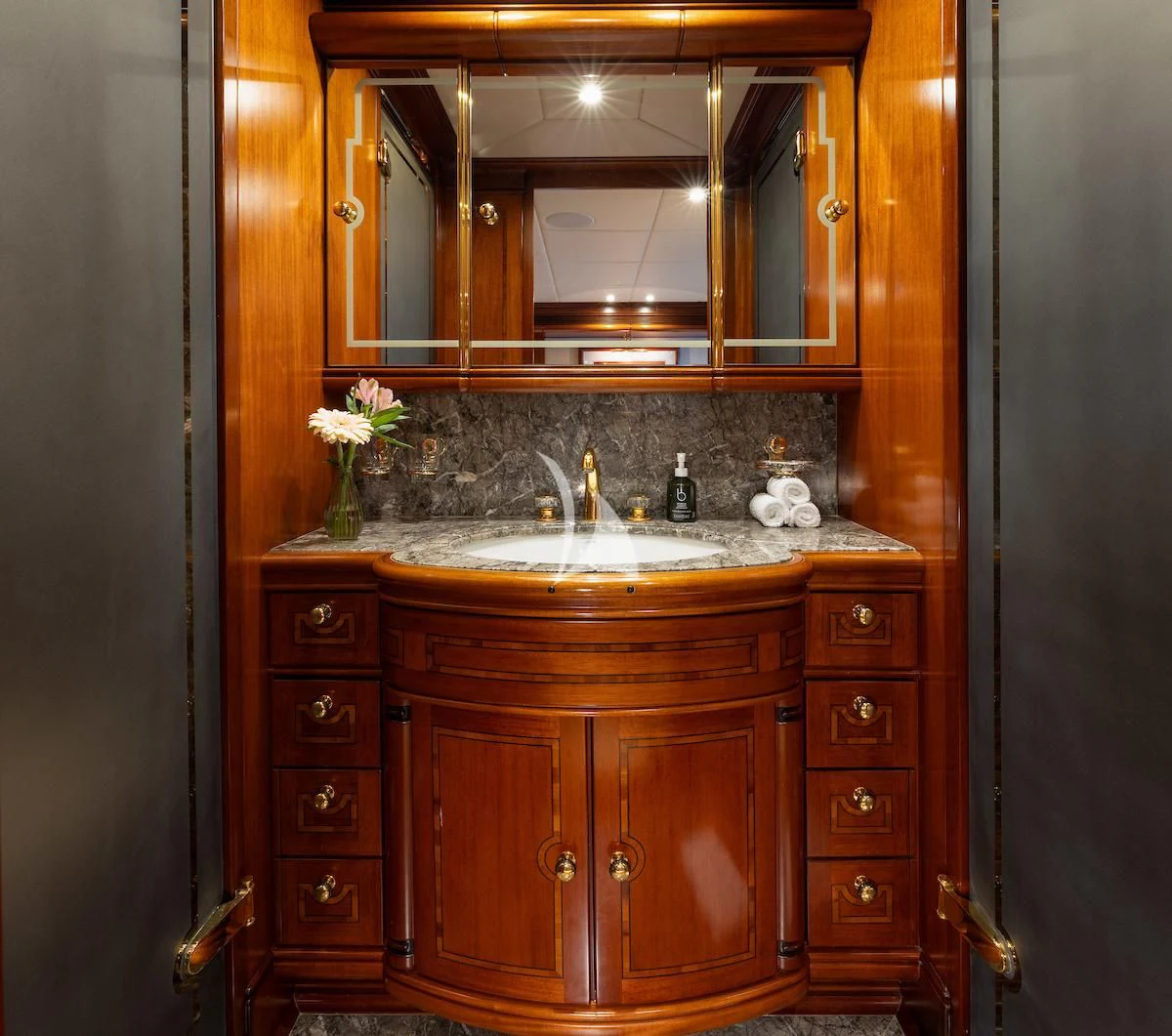 a bathroom with a sink and cabinets aboard HYPERION Yacht for Charter