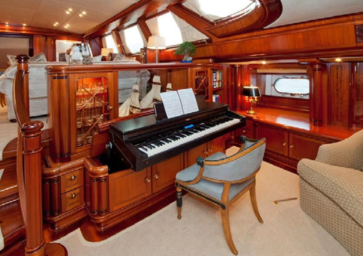 a piano in a room aboard HYPERION Yacht for Charter