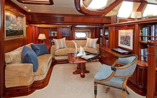 a living room with a couch and a table aboard HYPERION Yacht for Charter