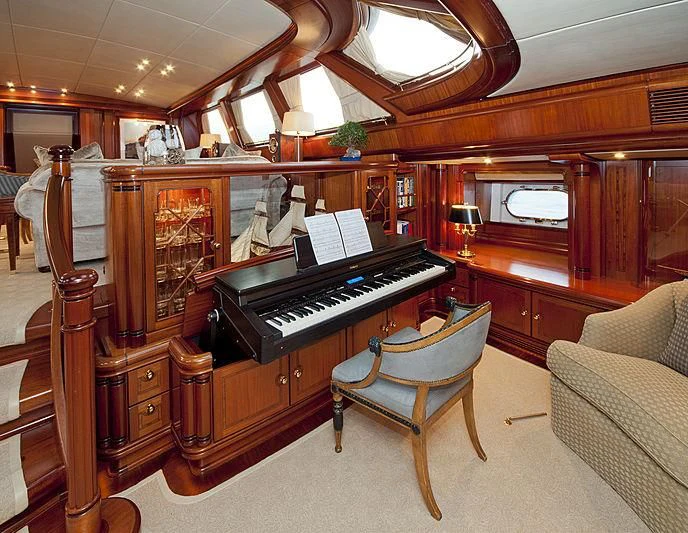 a piano in a room aboard HYPERION Yacht for Charter