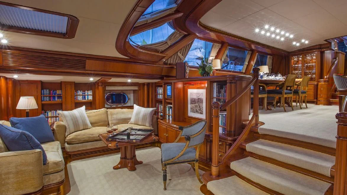 a room with a bed and a table aboard HYPERION Yacht for Charter