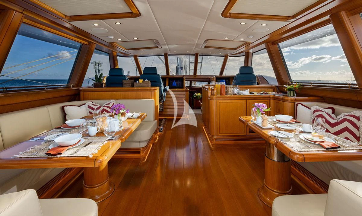 a room with tables and chairs aboard HYPERION Yacht for Charter