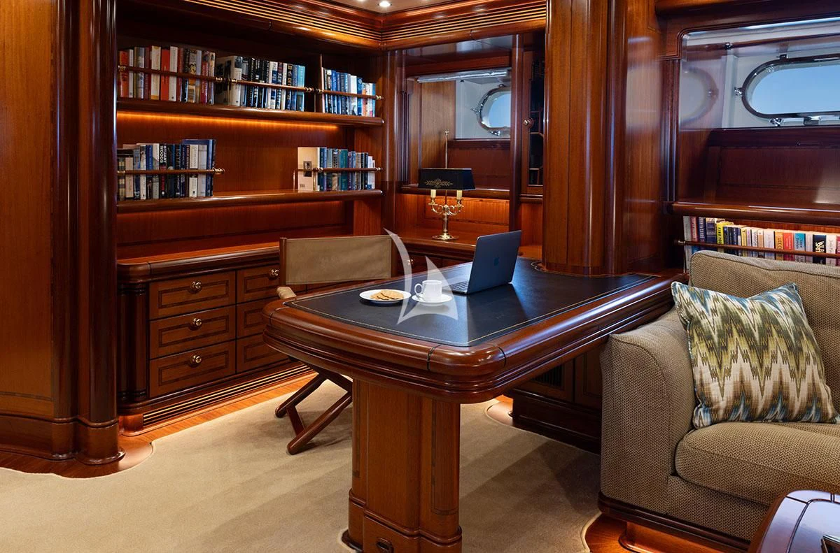a living room with a laptop on a coffee table aboard HYPERION Yacht for Charter