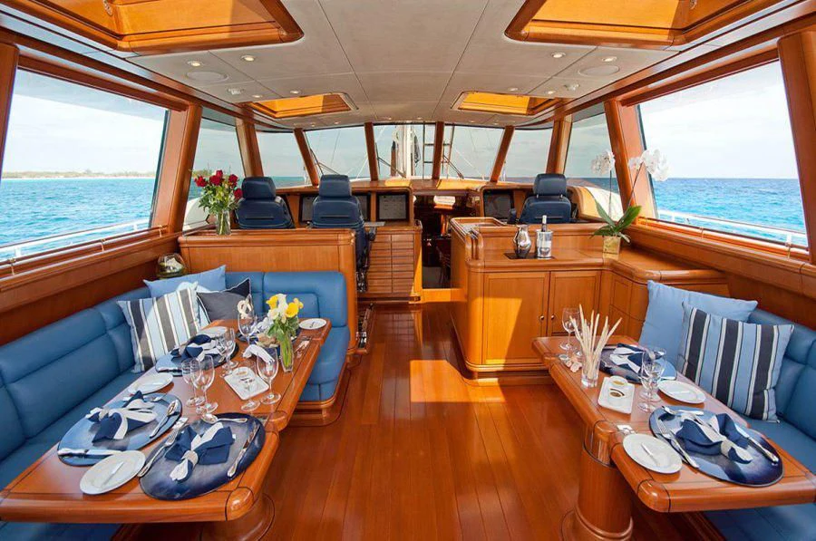 a dining room with a wood table aboard HYPERION Yacht for Charter