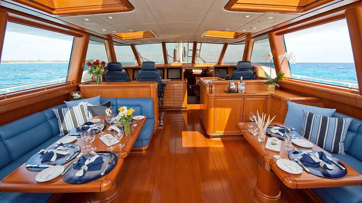 a room with a table chairs and a window aboard HYPERION Yacht for Charter