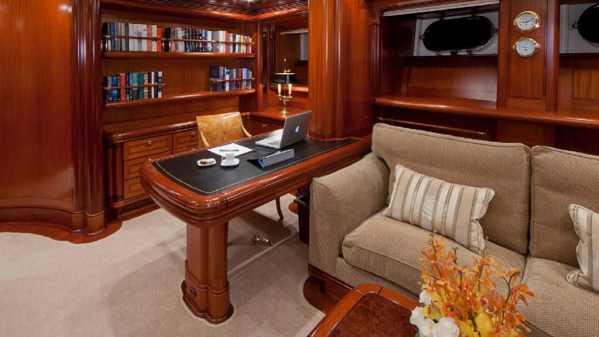 a laptop on a coffee table aboard HYPERION Yacht for Charter