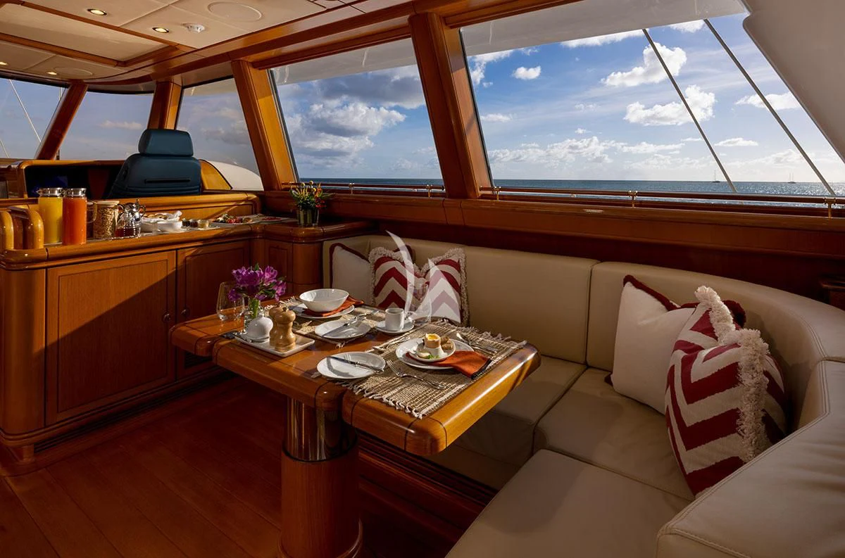 a room with a table and chairs aboard HYPERION Yacht for Charter