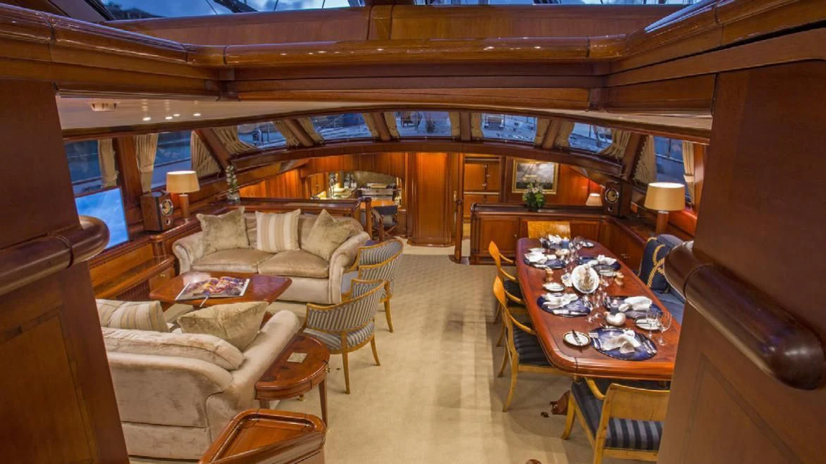 a living room with a table and couches aboard HYPERION Yacht for Charter