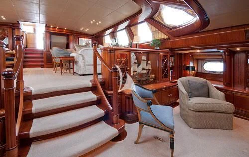 a room with a couch and a chair aboard HYPERION Yacht for Charter