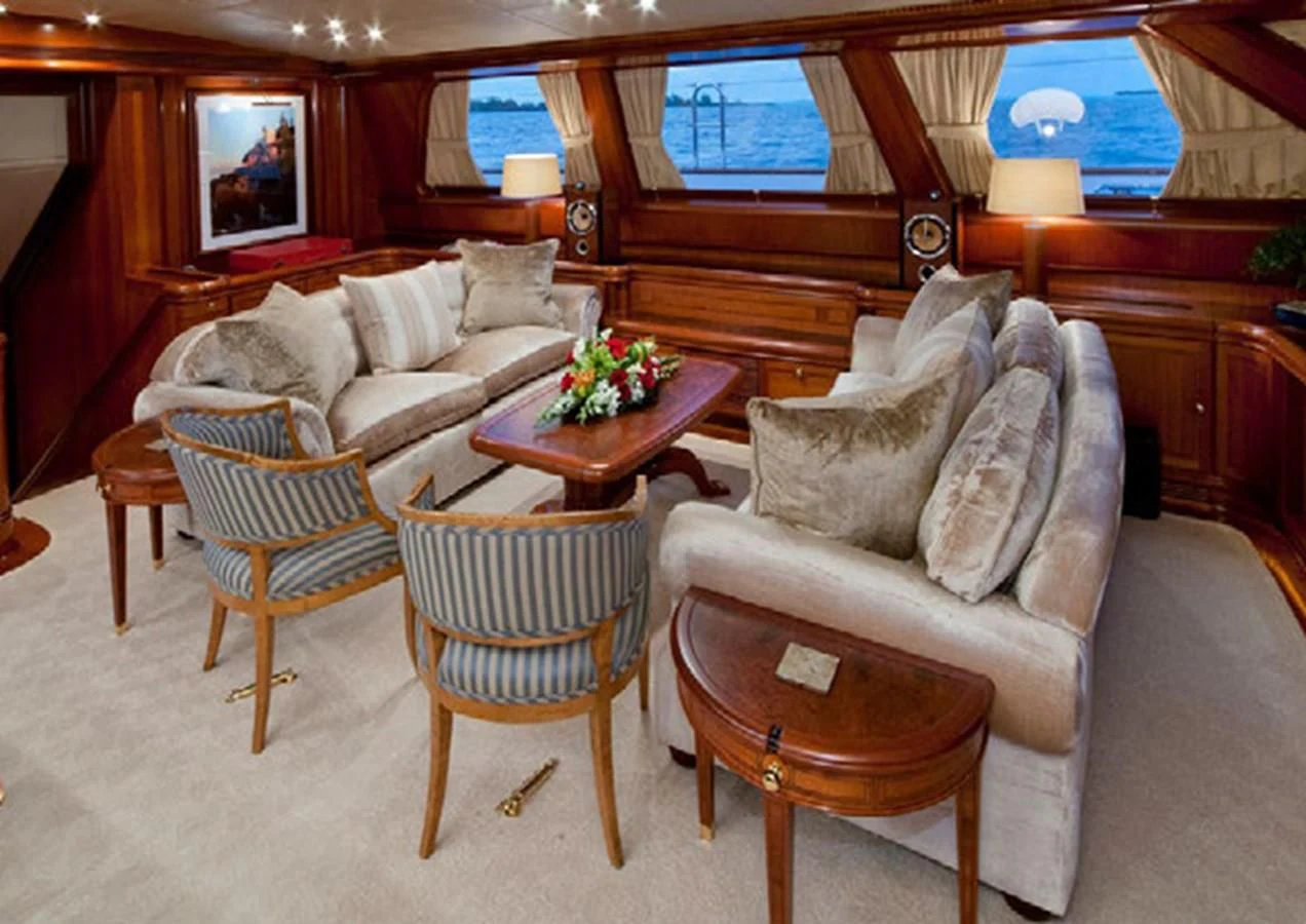a living room with a couch and a table aboard HYPERION Yacht for Charter
