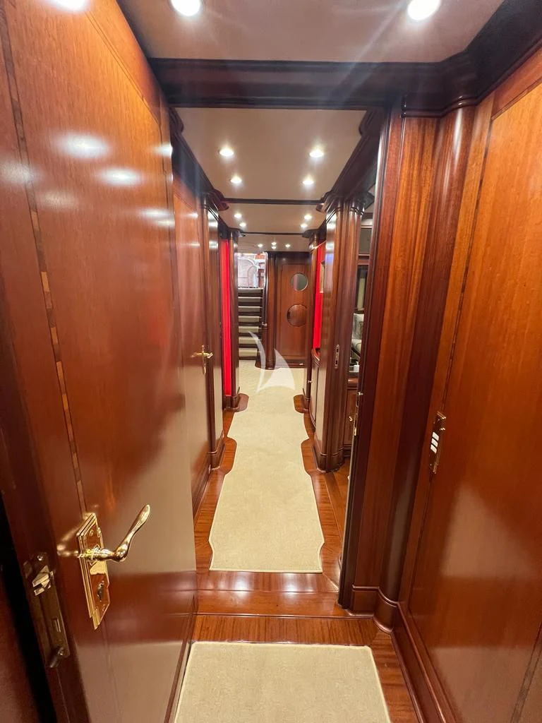 a hallway with a wood door aboard HYPERION Yacht for Charter