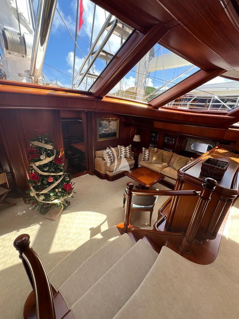 inside of a building with a large window and a table and chairs aboard HYPERION Yacht for Charter