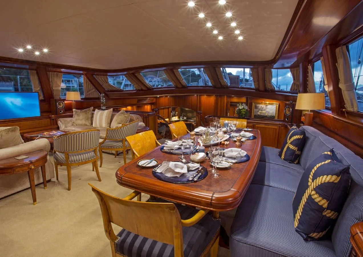 a large room with a table and chairs aboard HYPERION Yacht for Charter