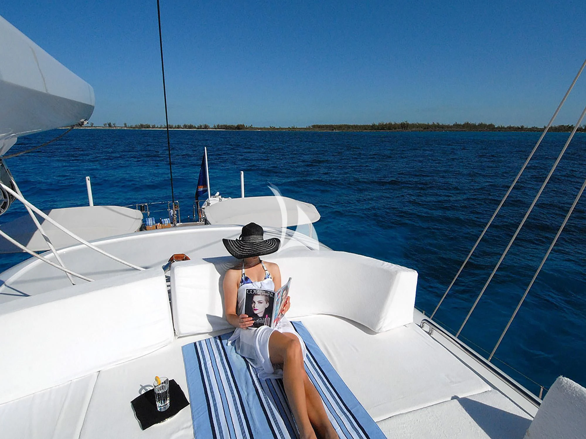 a woman taking a picture of a man on a boat aboard HYPERION Yacht for Charter
