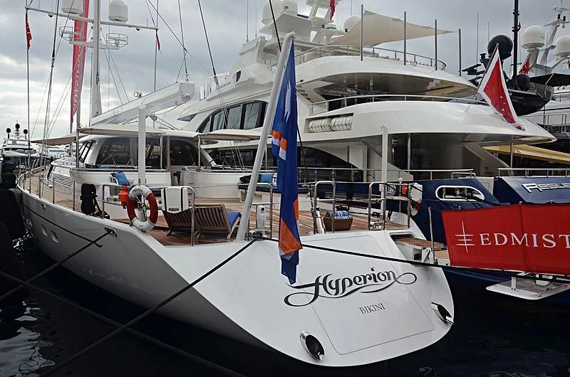 a boat with a blue and white flag on it aboard HYPERION Yacht for Charter