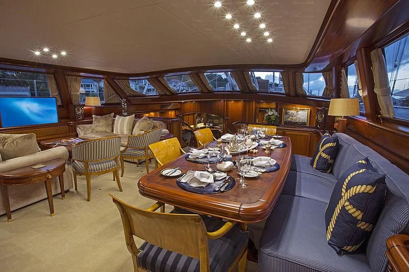 a large room with a table and chairs aboard HYPERION Yacht for Charter