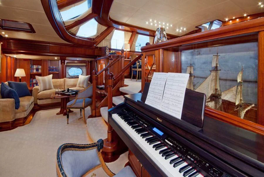 a piano in a room aboard HYPERION Yacht for Charter