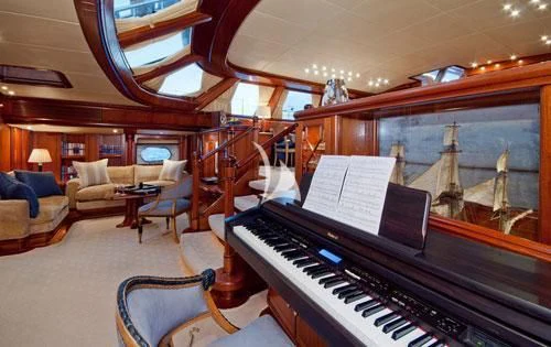 a piano in a room aboard HYPERION Yacht for Charter