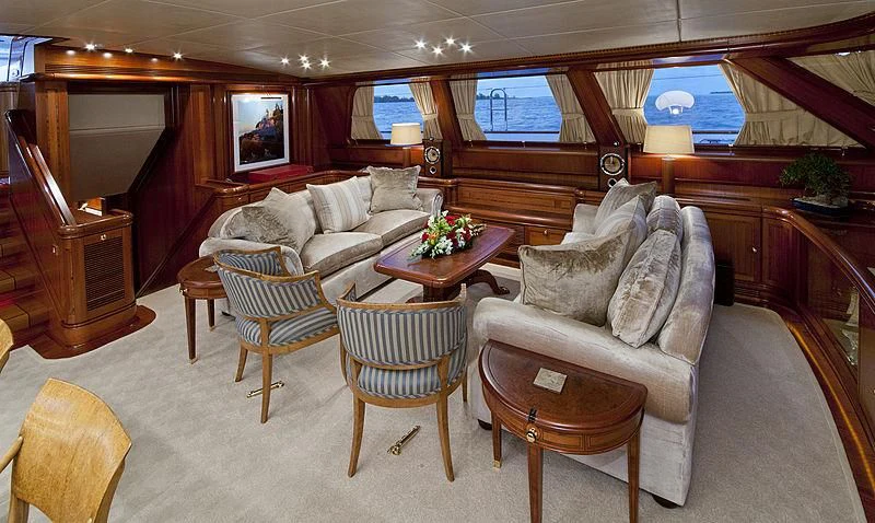 a room with a couch and a table and chairs aboard HYPERION Yacht for Charter